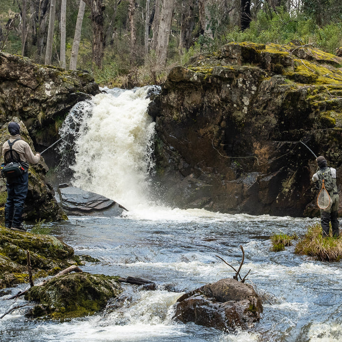 Pat and Dom fly fishing near a waterfall on Yarrangobilly River in Kosciuszko National Park
