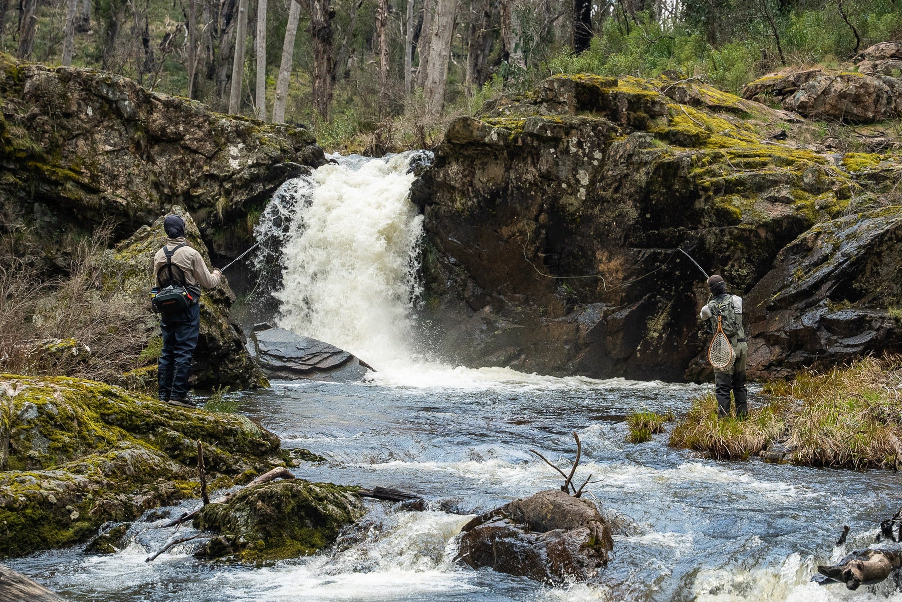 Pat and Dom fly fishing near a waterfall on Yarrangobilly River in Kosciuszko National Park