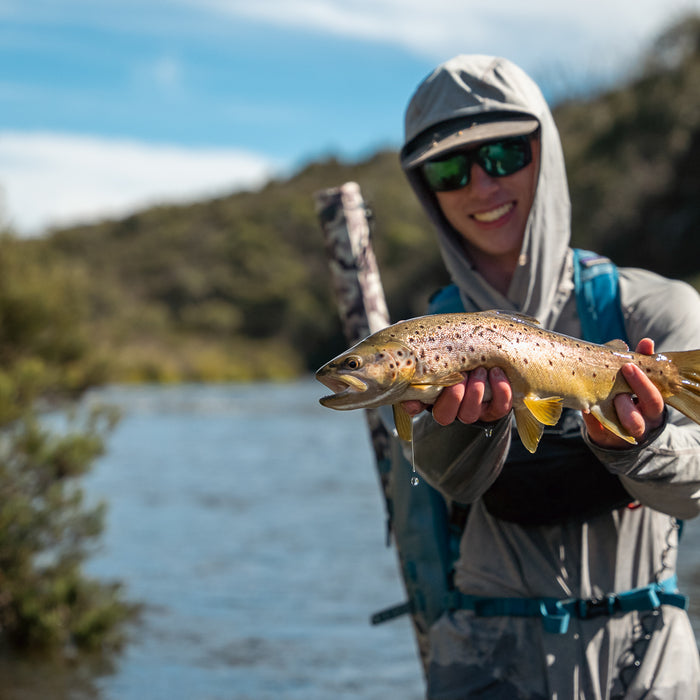 Pay Ryan holding a snowy mountains brown trout caught while fly fishing near Hains Hut in Kosciuszko National Park