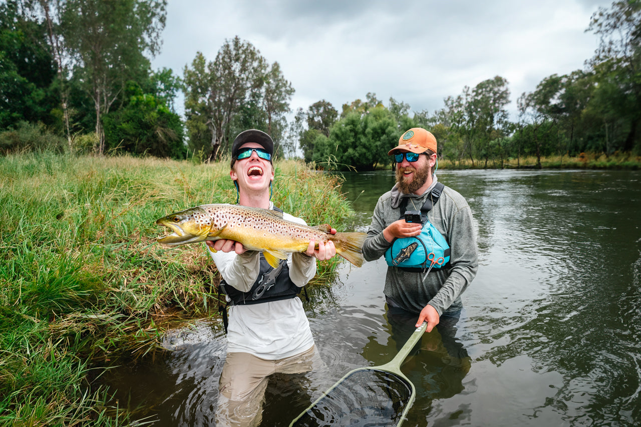 Fly fishing guide Pat holding a large brown trout caught fly fishing the Tumut River
