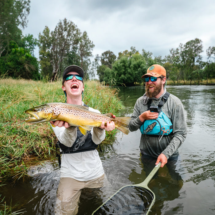 Fly fishing guide Pat holding a large brown trout caught fly fishing the Tumut River