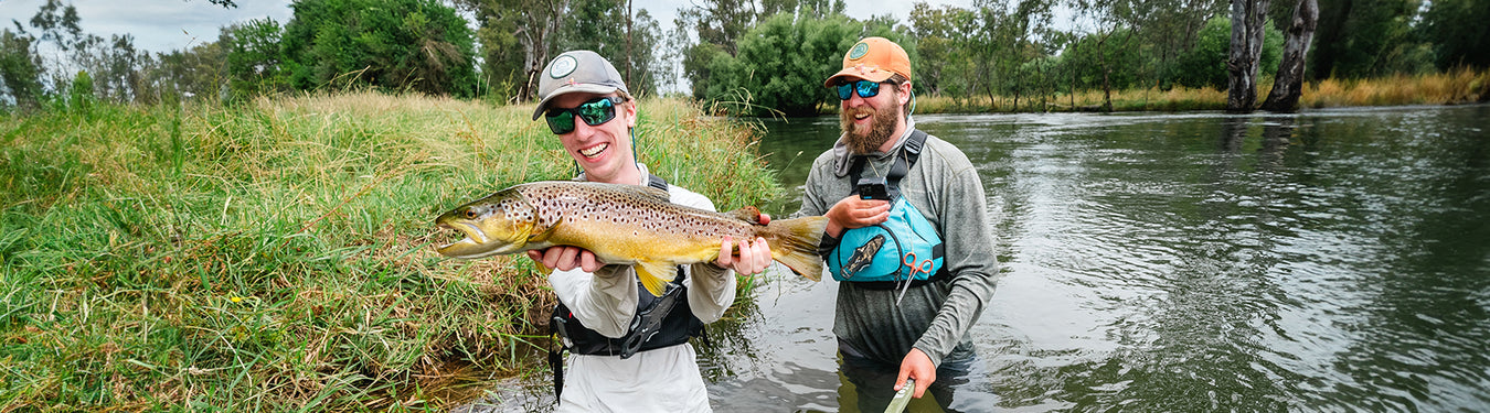 Pat holding a brown trout caught fly fishing in the Tumut River