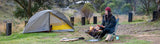 Anna warming her hands over the campfire, at Blue Waterholes in Kosciuszko National Park